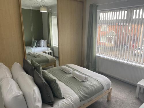 a hotel room with a bed and a mirror at Wilton - Perfect Home for Contractors Private Large Drive in Newcastle upon Tyne