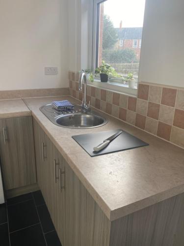 a kitchen counter with a sink and a window at Wilton - Perfect Home for Contractors Private Large Drive in Newcastle upon Tyne