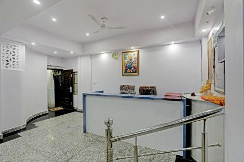 a lobby with a blue counter and white walls at S B Guest House Near New Delhi Train Station in New Delhi