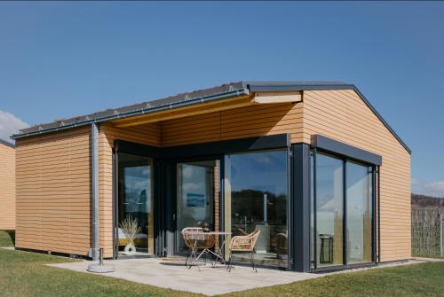 a house with glass doors and a table at Weinberg Chalets in Malsch