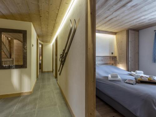 a bedroom with a large bed with a wooden ceiling at Chalet La Clusaz, 8 pièces, 13 personnes - FR-1-304-177 in La Clusaz