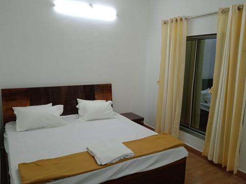 A bed or beds in a room at Green Woods Resort Near Kashid beach