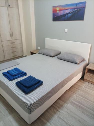 a bedroom with a bed with blue towels on it at Alimos Apartments in Athens