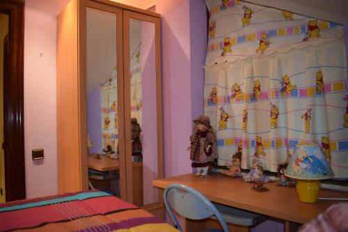 a room with a bed and a table with dolls at Casa Villa Mey in Candás