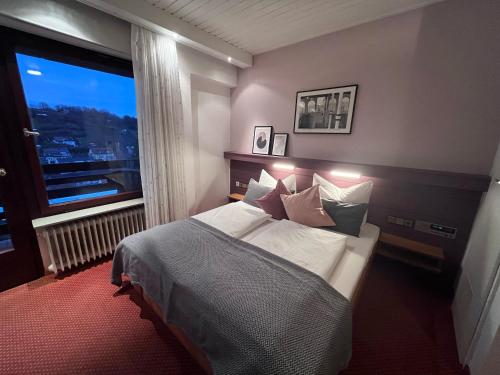 a bedroom with a bed and a large window at Haus am Wald in Eltmann