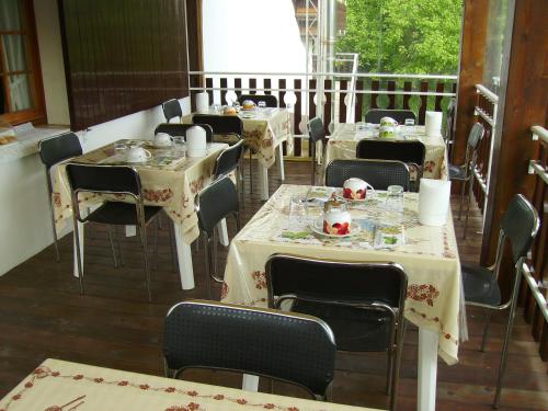 a dining room with tables and chairs on a balcony at Il Prato in Predappio