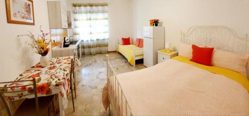 1 dormitorio con 2 camas y escritorio en Fiori e Frutti - Appartamento Economy, en Almese