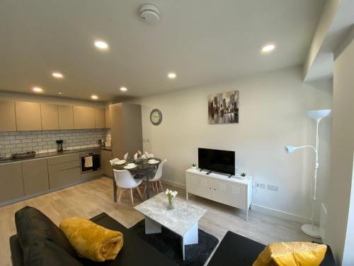 a living room with a couch and a table at Snapos Apartments - Platform A in Bedford