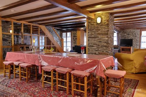 a dining room with a table and some chairs at Chalet Font in Soldeu