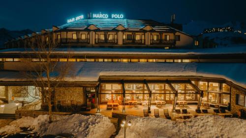 a hotel in the snow at night at Marco Polo Hotel Gudauri in Gudauri