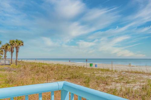 a view of a beach with palm trees and the ocean at Southern Breeze Ocean Front Hotel in Myrtle Beach