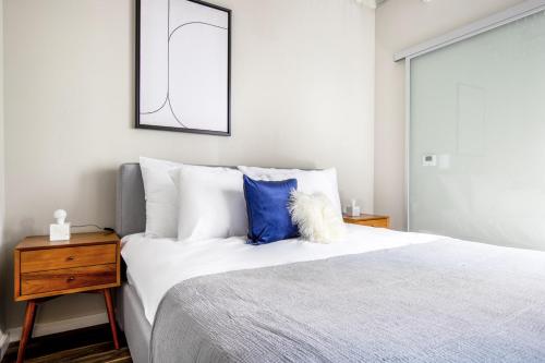a bedroom with a large bed with a blue pillow at Loop 1BR w Gym Roof nr Millennium Park CHI-387 in Chicago