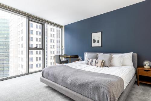 a blue bedroom with a large bed and a desk at Loop 2BR w Pool Gym nr Financial District L CHI-247 in Chicago