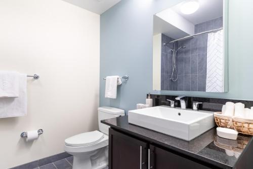a bathroom with a white sink and a toilet at Loop 2BR w Pool Gym nr Financial District L CHI-247 in Chicago