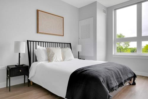a white bedroom with a large bed and a window at Arlington Heights 2BR w Gym WD nr I-90 CHI-687 in Arlington Heights