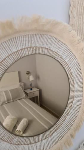 a mirror reflecting a bedroom with a bed in a room at Vacacional Buyma - Parking privado -GRATUITO- in Málaga