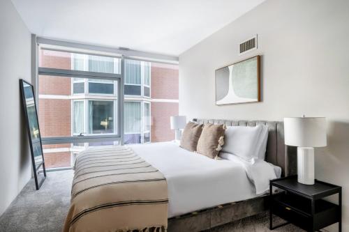 a bedroom with a large bed and a large window at Streeterville 1br w pool gym nr Riverwalk CHI-878 in Chicago