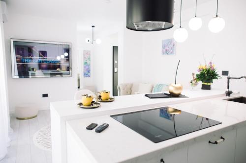 a white kitchen with a large white counter top at AM Apartments Timișoara Comfort and Free Parking in Timişoara
