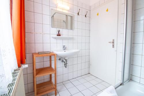 a bathroom with a sink and a mirror at Burg Rotraut #5 in Ostseebad Sellin
