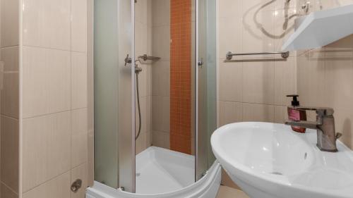 a bathroom with a shower and a sink and a toilet at Apartment Sana with Sea View in Novigrad Istria