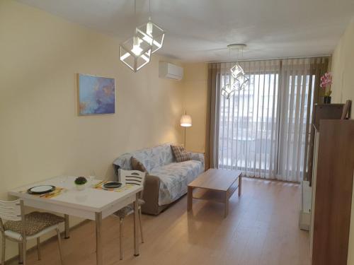 a living room with a couch and a table at Augusta Apartment in Stara Zagora