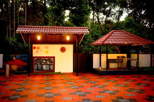 a small pavilion with a table and a pavillion at SILVERY MOON GRAND VILLA in Tariyod