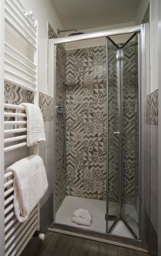 a shower with a glass door in a bathroom at B&B My Way in Florence