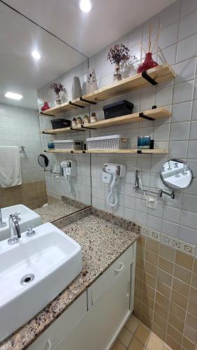 a bathroom with a sink and a counter top at Meu Resort no Recreio - RJ in Rio de Janeiro