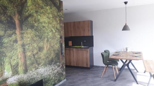a dining room with a wall mural of trees at Hof Schütterle in Friedrichshafen
