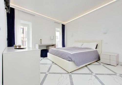 a white bedroom with a bed and a tiled floor at Exclusive Apartment Spagna View on Spanish Square in Rome