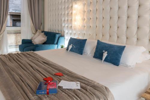 a bedroom with a large white bed with blue pillows at Argentina Residenza Style Hotel in Rome