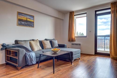 a living room with a couch and a table at Complex Silver Hills in Smolyan