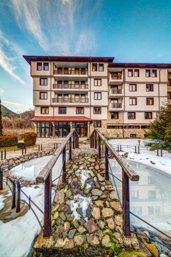 a large building with a bridge in front of it at Complex Silver Hills in Smolyan