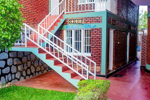 a brick building with a staircase on the side of it at MOUCECORE in Kigali