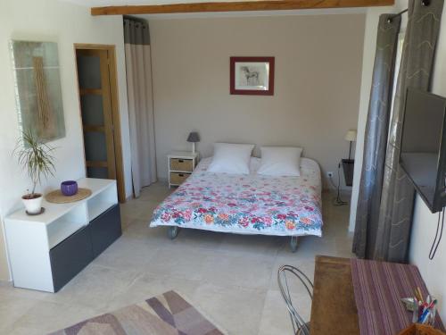 a bedroom with a bed and a dresser in it at Campagne de Saint Clair in Pertuis