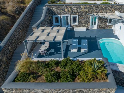 an aerial view of a villa with a swimming pool at Amber Light Villas in Imerovigli