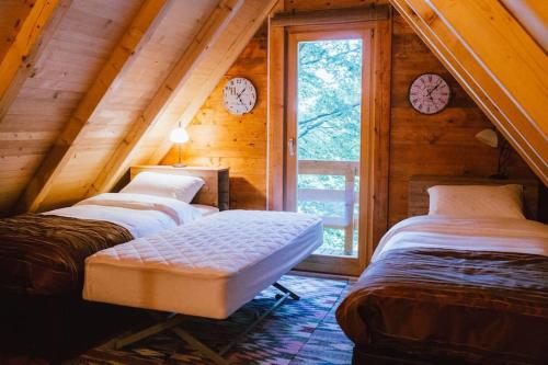 A bed or beds in a room at Treehouse Bosnia