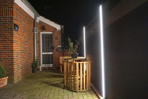 a house with a porch with a door with lights at Burghaus 4 in Greetsiel