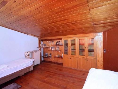 a bedroom with a wooden ceiling and wooden floors at Wooden_Room_Hostel in Yerevan