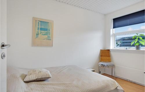 a white bedroom with a bed and a window at 2 Bedroom Nice Apartment In Skagen in Skagen