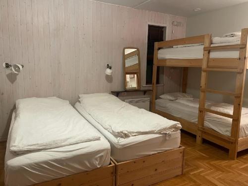 two bunk beds in a room with a mirror at ÖXL Snæfellsnes in Snæfellsbær