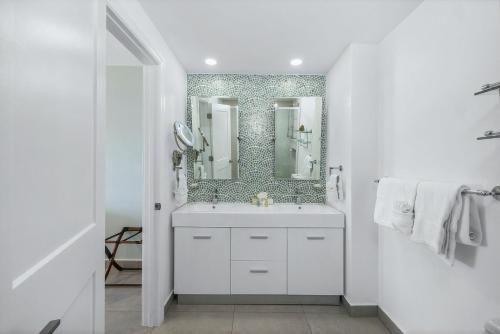 a bathroom with a white sink and a mirror at Oceanview Paradise In The One Happy Island in Oranjestad