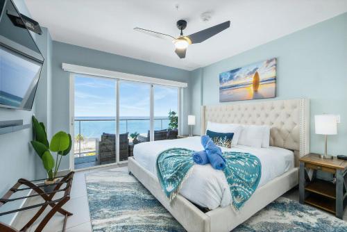 a bedroom with a large bed and a large window at Oceanview Paradise In The One Happy Island in Oranjestad