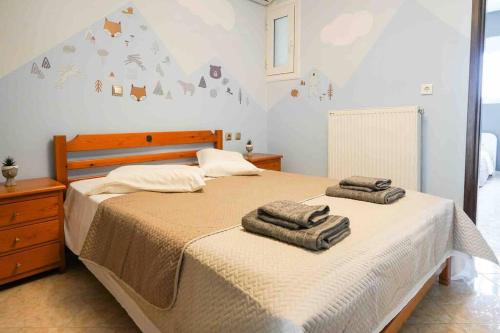 a bedroom with two towels sitting on a bed at Neochori House in Antimácheia