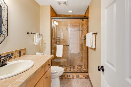 a bathroom with a shower and a sink and a toilet at Sand & Sea: Neawanna Creek (414) in Seaside