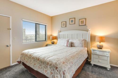 a bedroom with a white bed and a window at Sand & Sea: Neawanna Creek (414) in Seaside