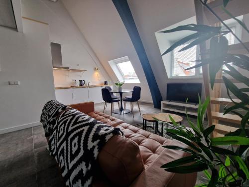a living room with a couch and a table at Woonhotel Petruskerk in Vlissingen
