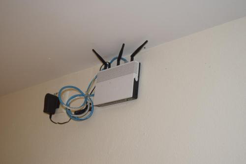 a tv hanging on the side of a wall at Federal Hotel Kangar Perlis in Kangar