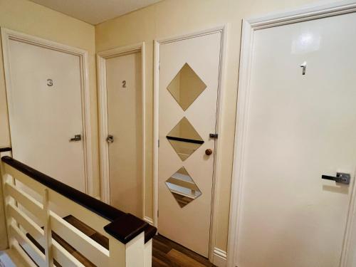 a hallway with a door and a stair case at Reading West Homestay in Reading