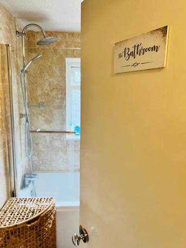 a bathroom door with a bathroom sign on the wall at Reading West Homestay in Reading